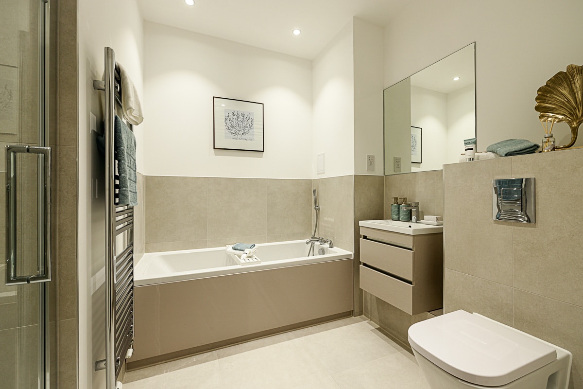 A bathroom space in a home a Terlingham Gardens with a bath and separate shower.