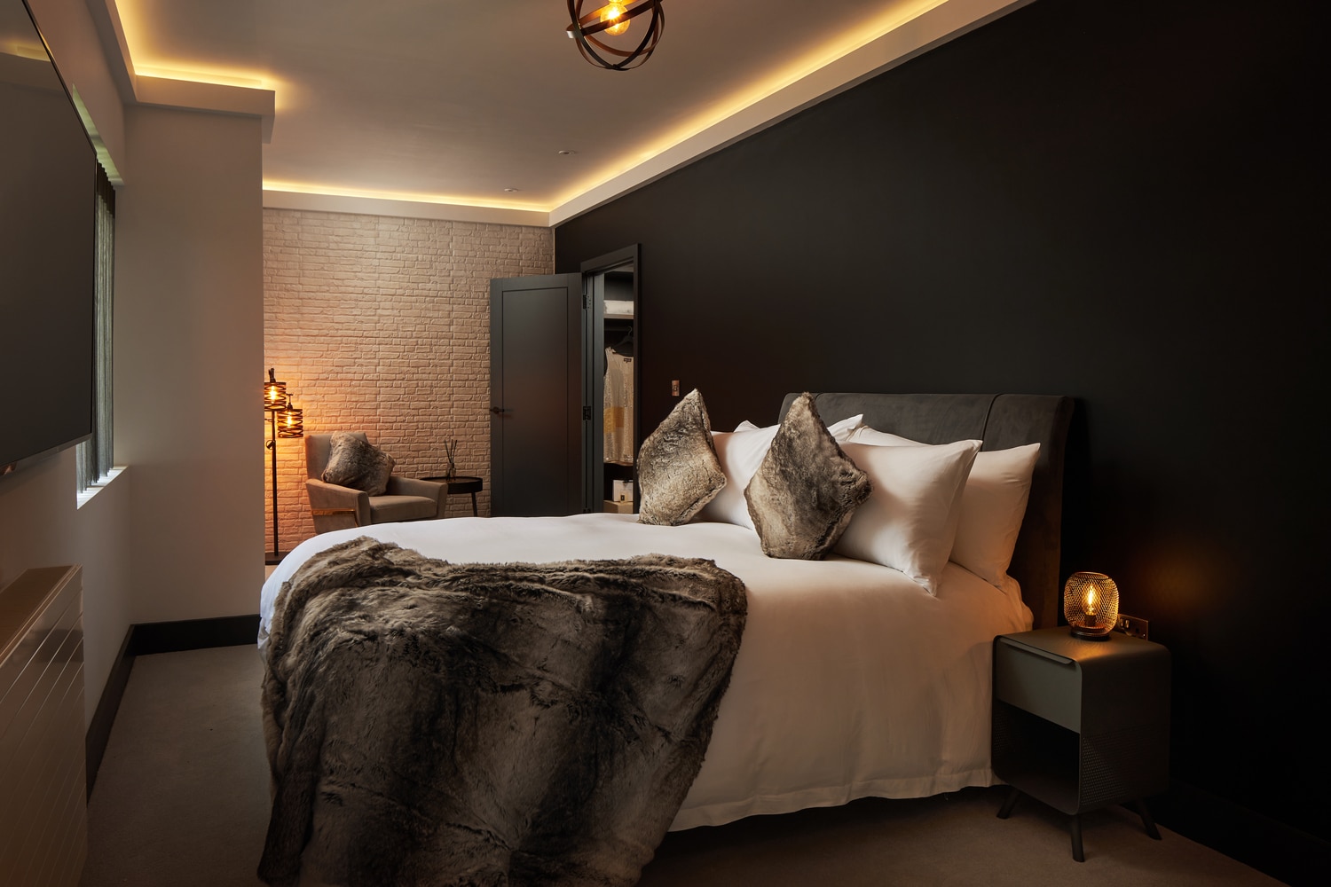 A bedroom showing a bed and a bedside table in a Hawker 6, apartment home by Pentland Homes.