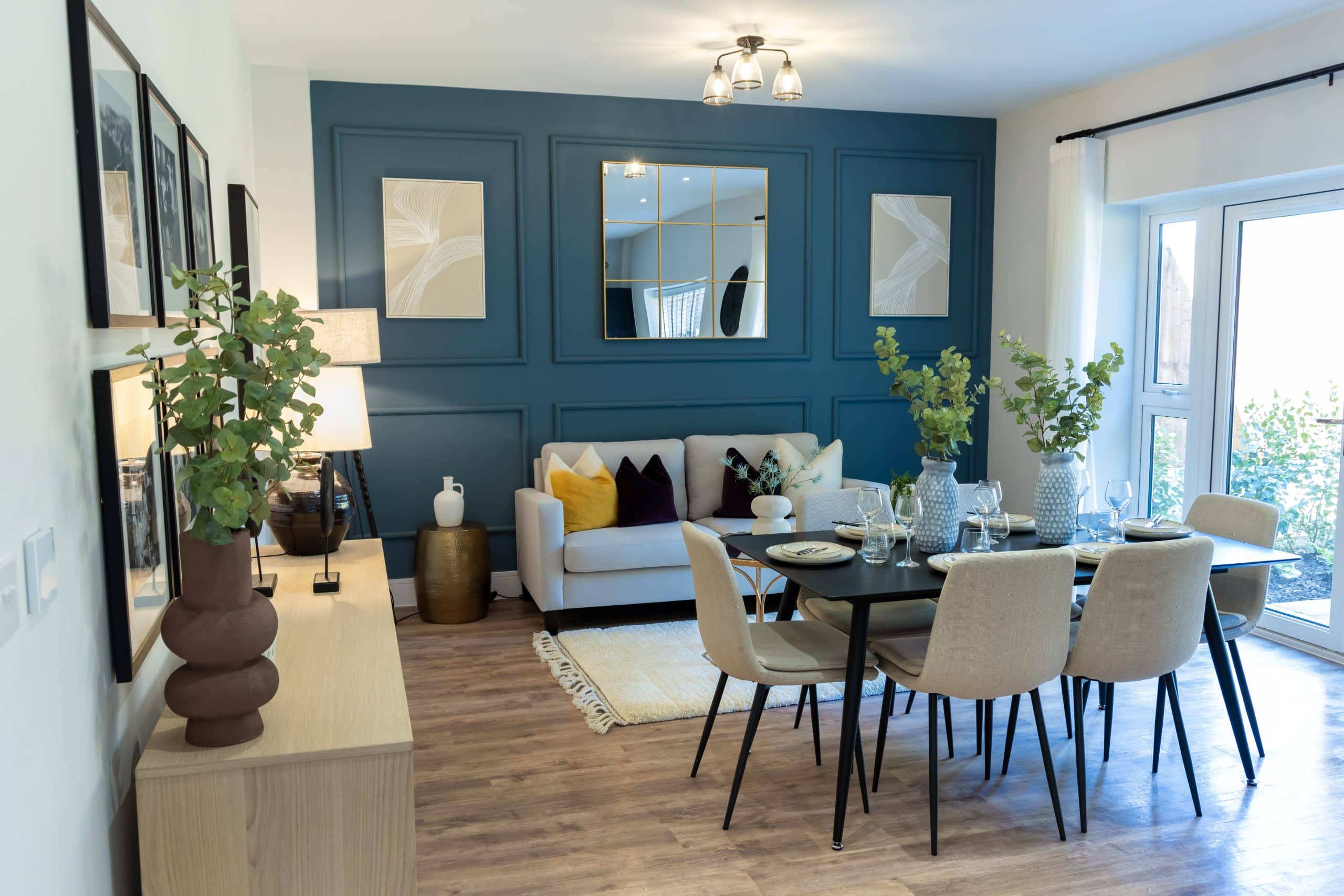 The dining area including dining table and sofa of a poppy fields home.