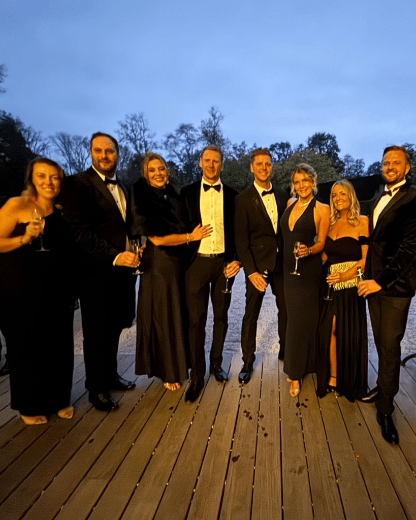 A group of 6 people dressed in black tie for a charity ball