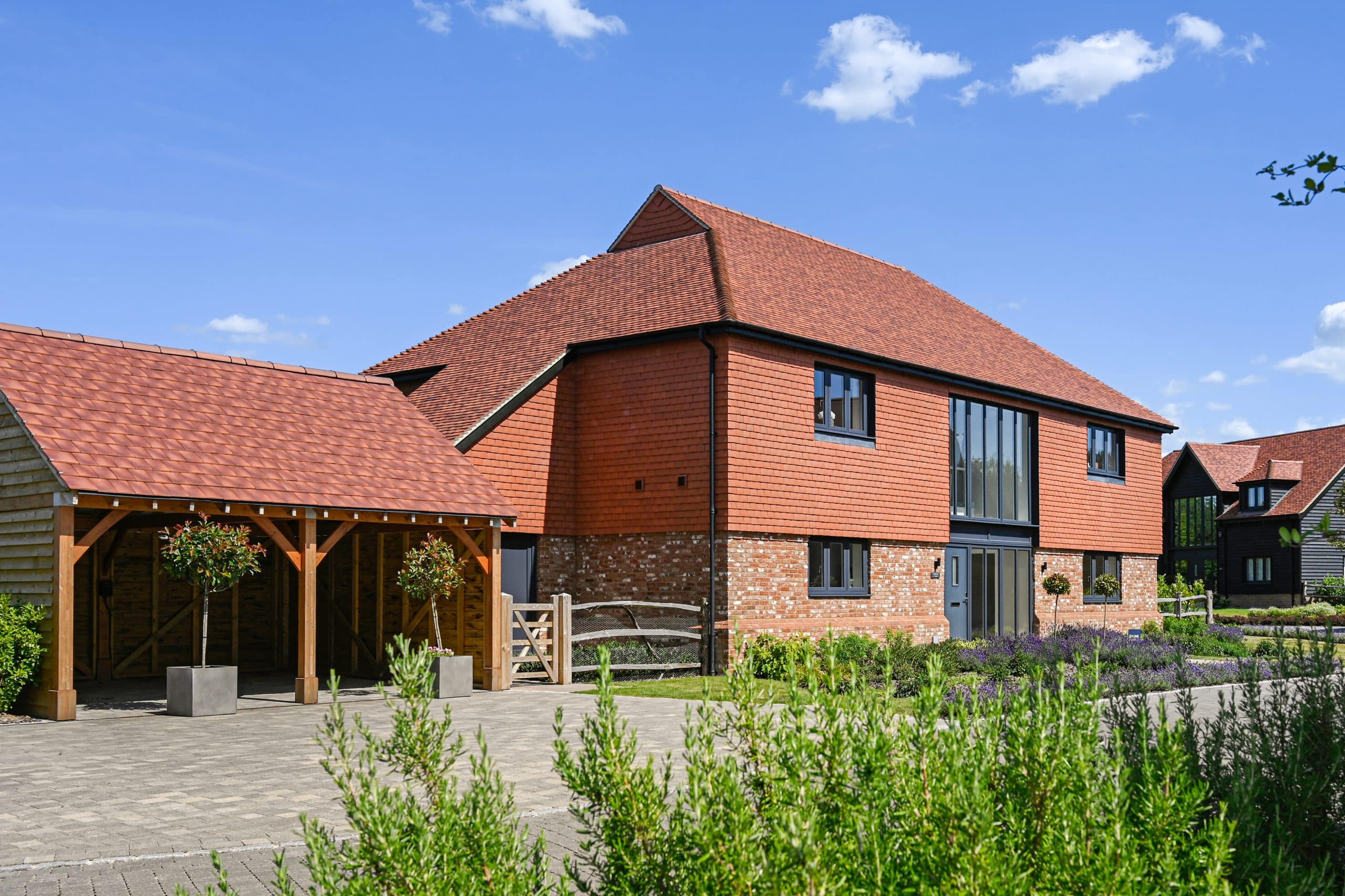 Rosewood house at the Barns at wye behind a green plant.