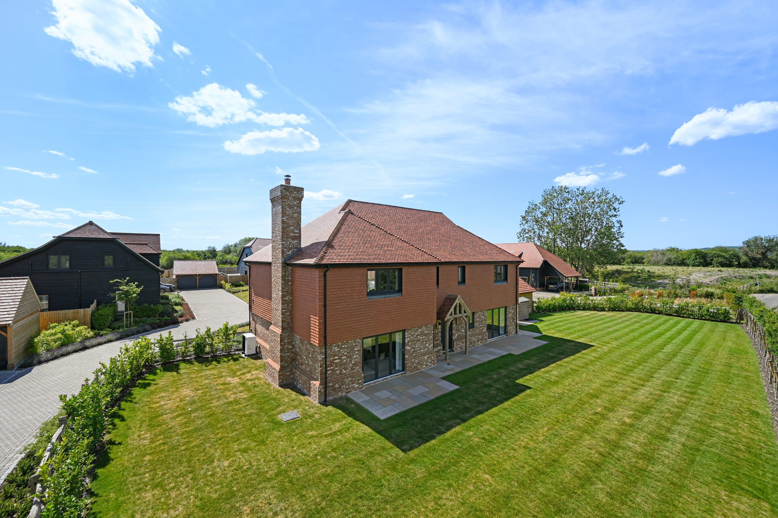 The back view of rosewood house at the barns at wye, showing the garden and back view.
